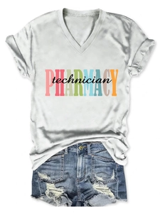 Flat lay of a white V-neck pharmacy technician T-shirt paired with ripped denim shorts