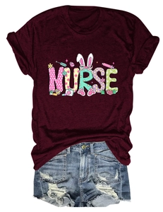 Detailed flat lay of burgundy nurse T-shirt with Easter bunny prints and denim shorts
