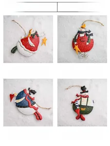 Detail view of colorful painted metal snowman ornaments for Christmas tree decoration