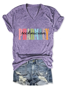 Flat lay of purple V-neck pharmacy technician tee paired with ripped denim shorts