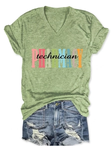 Flat lay of green Pharmacy Technician V-neck T-shirt paired with distressed denim shorts