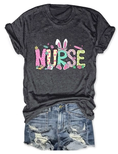 Flat lay of gray Nurse T-shirt with Easter bunny elements and ripped denim shorts