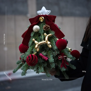 Detailed view of a 40cm mini Christmas tree with velvet bows and golden balloon dog decor