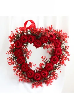 Macro detail of artificial red rose heart wreath with hanging ribbon for Valentine's Day