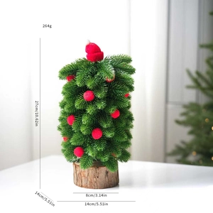 Mini artificial Christmas tree detail with red hat, berry ornaments, and wood base