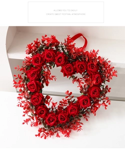 Close-up of heart-shaped red rose wreath with silk ribbon for Valentine's Day decor