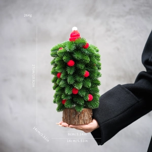 Mini desktop Christmas tree with red knit hat and wooden base 27cm height