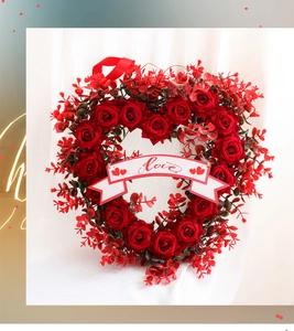 Detailed view of red rose heart wreath with a white Love banner and silk ribbon