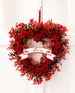 Close-up of red rose heart wreath featuring a white banner with Love text for decor
