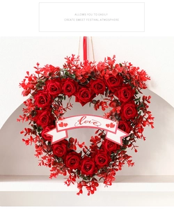 Detail of a heart-shaped red rose wreath with a white Love banner for romantic decor