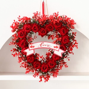 Red rose heart wreath with a white love banner for Valentine's Day party decor