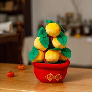 Detail of plush orange tree decoration with golden lucky embroidery on a red pot