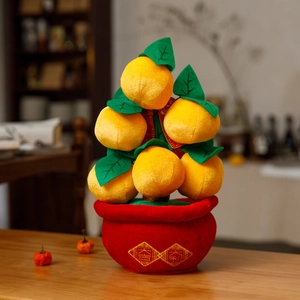 Detail of plush orange tree decoration with golden lucky calligraphy for Lunar New Year
