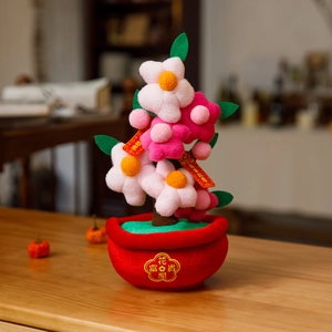 Detail of plush floral ornament with pink flowers and golden rich embroidery on red pot