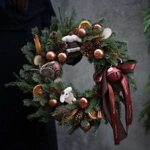 Classic American Christmas wreath with pine cones and Merry Christmas ribbon decoration