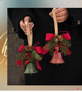 Detail of Christmas bell ornaments with pine cones, red berries, and burlap bows