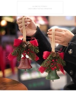 Macro shot of rustic Christmas bell with burlap bow, pine needles, and pine cones detail