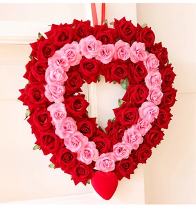 Detail of red and pink artificial rose heart wreath with a hanging string for door decor