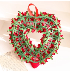 Detailed back view of heart-shaped rose wreath with red flowers and a hanging rope