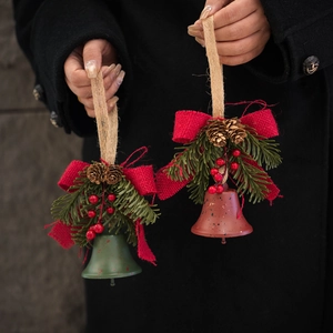 Handheld vintage Christmas bells with red burlap bows, pinecones and berries for tree decor