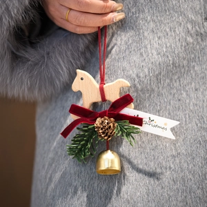 Handcrafted wooden Christmas horse hanging ornament with velvet bow and golden bell