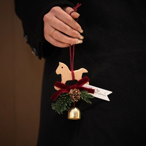Handcrafted Christmas wooden rocking horse car ornament with red velvet bow and pine cone