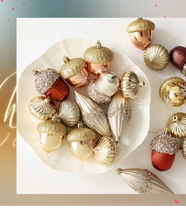 Detailed view of champagne and burgundy acorn-shaped Christmas ornaments on white plate