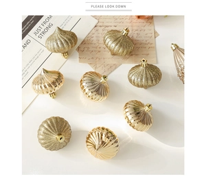 Macro view of burgundy champagne onion shaped Christmas baubles with glitter texture