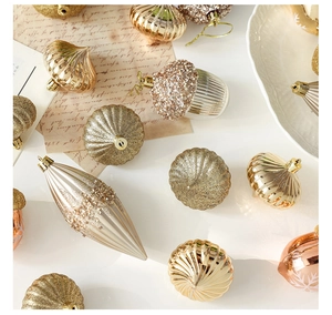 Detail of elegant champagne and rose gold Christmas ornaments with glitter and matte finish