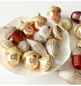 Close-up of assorted champagne and burgundy Christmas ornaments with glitter details