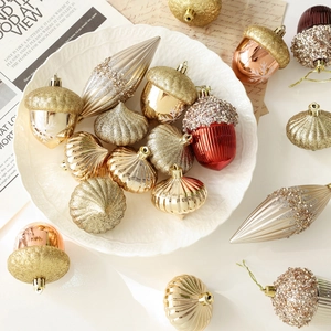 Elegant champagne and burgundy Christmas ball ornaments set displayed on a white plate