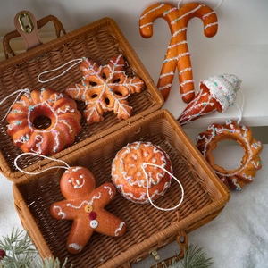 Christmas gingerbread man foam ornaments with snowflakes and candies in a woven basket