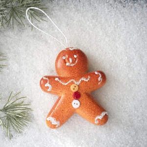 Gingerbread man ornament with white icing patterns and festive colorful buttons detail