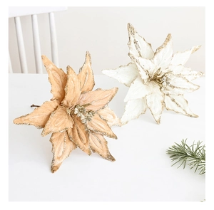 Detail of champagne and ivory velvet poinsettias with gold glitter edges for decor
