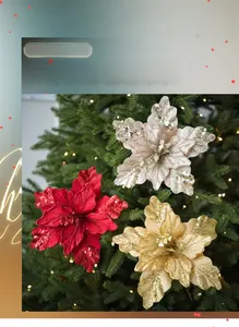 Close-up of sparkling fabric poinsettia flowers on Christmas tree with glitter detail