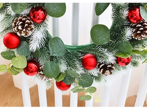 Close-up of 40cm Christmas wreath with eucalyptus leaves, pine cones, and red ornaments