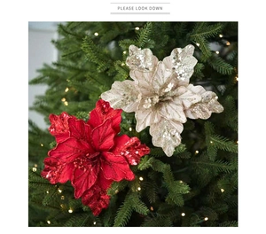 Sparkling velvet Christmas flower with sequins on a decorated tree, close-up detail