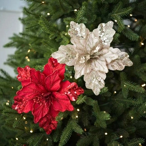 Red and champagne artificial Christmas flowers with sequins on a festive tree