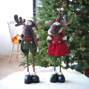 Pair of Nordic knitted Christmas reindeer dolls in festive red and green plaid outfits