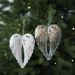 Sparkly Christmas tree hanging angel wings with sequins in transparent and white