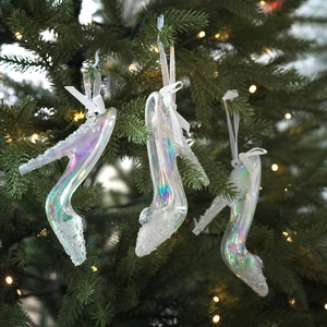Holographic high heel Christmas ornaments with glitter details on a festive tree