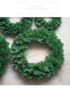 Detail of multiple green artificial pine needle wreaths layered for Christmas decor