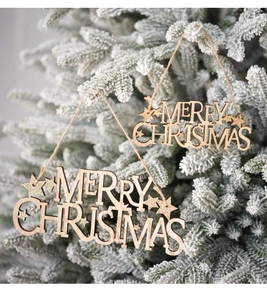 Détail de plaques de Noël en bois avec étoiles dorées suspendues sur un sapin givré