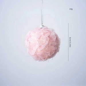 Detail of pink plush Christmas ball ornament with petal lace texture and hanging string