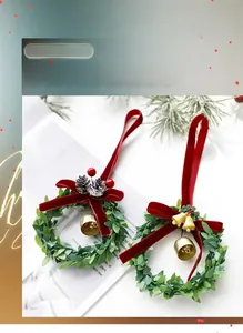 Mini Christmas wreath with red flocking bow, silver pinecone, and festive bells