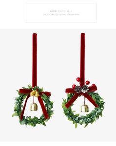 Detail of Christmas mini wreaths with red velvet bows, gold bells, and winter berries