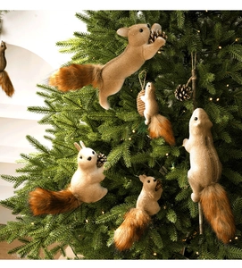 Details von Plüsch-Eichhörnchen-Anhängern mit Tannenzapfen am Weihnachtsbaum