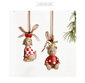 Detail view of festive dog and teddy bear resin Christmas ornaments with red scarves