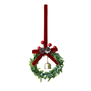 Christmas wreath ornament with red velvet bow, berries, pinecones and gold bell on white background