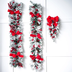Christmas garland and swag set with flocked pine, red berries, cones, and bows